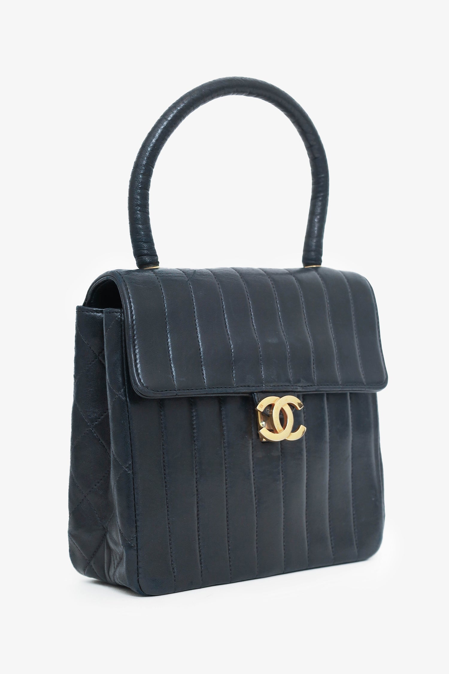 Chanel™ -94 Black Vertical Quilted Lambskin Top Handle Bag
