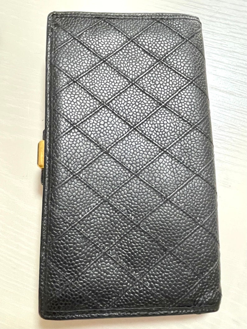 Chanel   black caviar leather wallet with stitches and gold tone CC motif