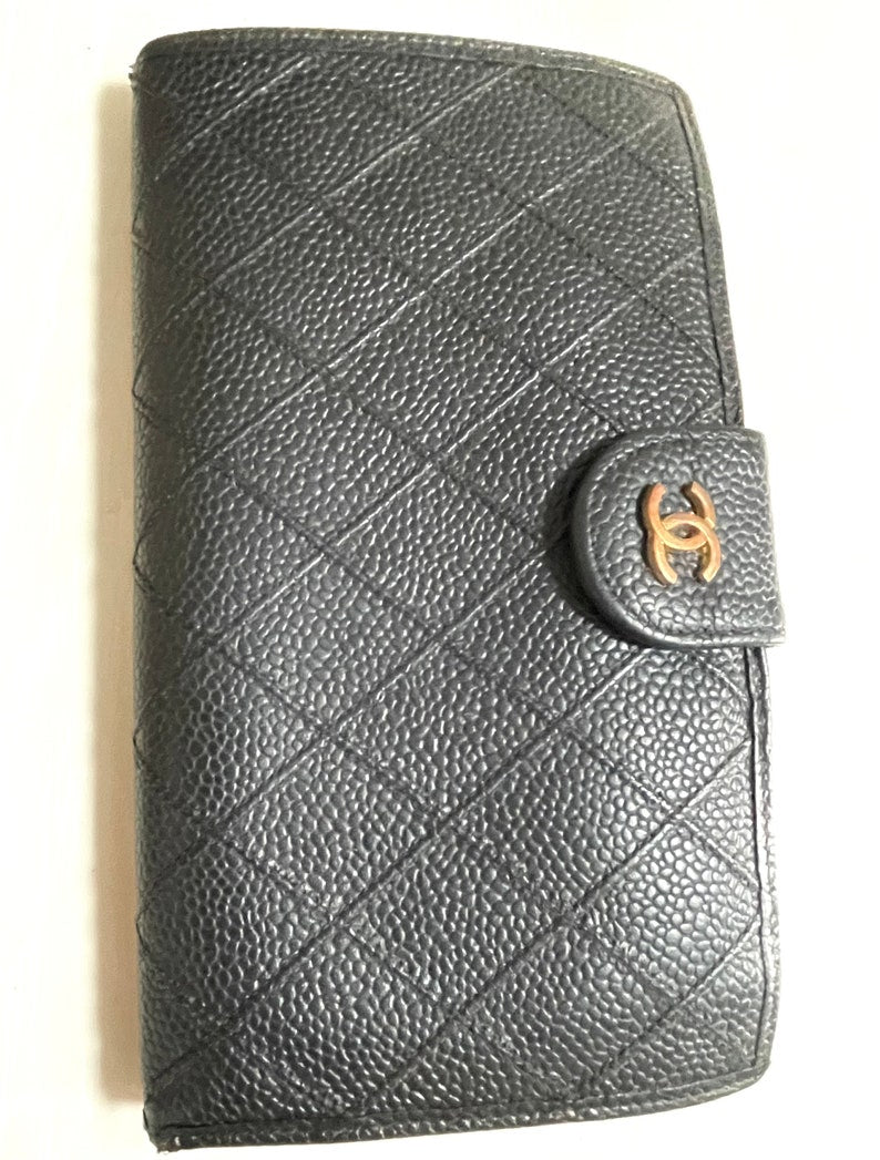 Chanel   black caviar leather wallet with stitches and gold tone CC motif